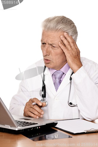 Image of Elderly doctor with a laptop