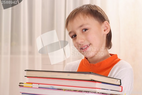 Image of Young boy with books