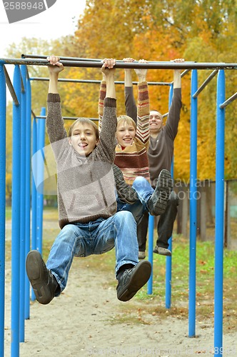 Image of Father and sons in park