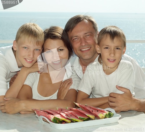 Image of Beautiful family eating watermelon