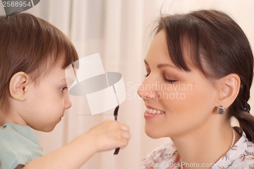 Image of Daughter making up her mother