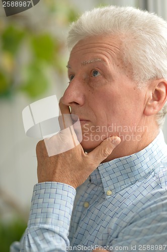 Image of Caucasian elderly man at home