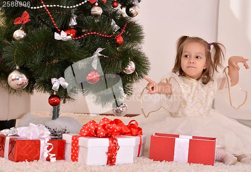 Image of Little girl with Christmas gifts