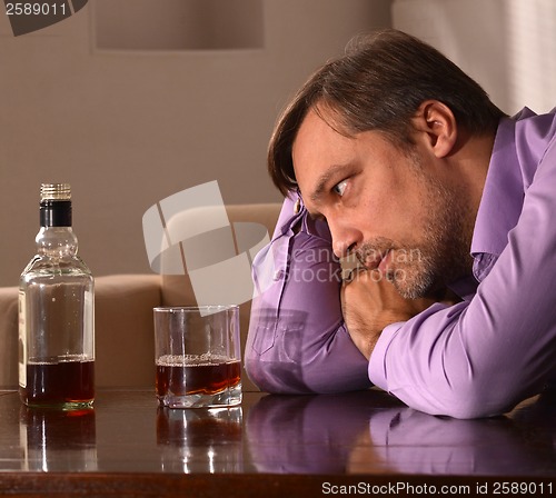 Image of Man drinking whiskey