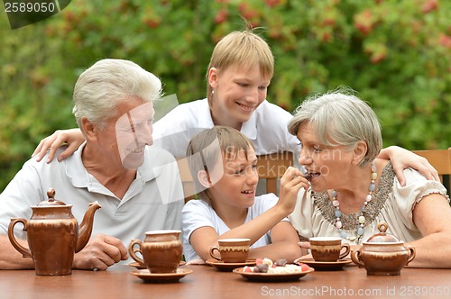 Image of Family drinking tea outdoors
