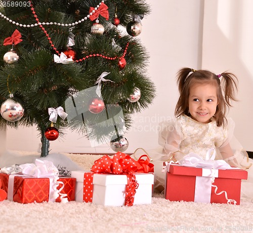 Image of Little girl with Christmas gifts