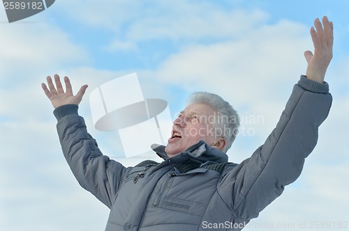 Image of Elderly man standing outdoors