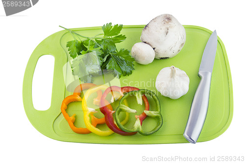 Image of Parsley and mushroom on green Plastic board
