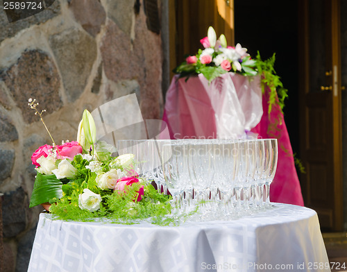 Image of Bouquet of flowers and wine glasses for a wedding table 