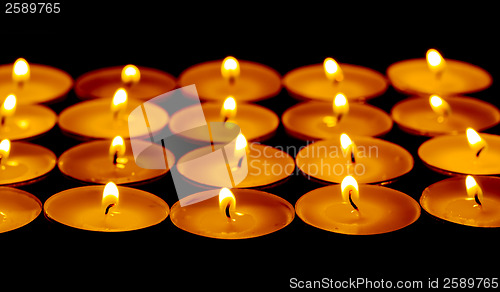 Image of Tea lights candles with fire