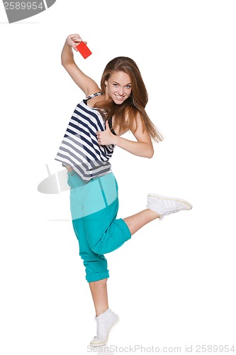 Image of Excited teen girl smiling showing credit card