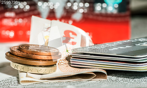 Image of Coins, credit cards and british pounds on newspaper