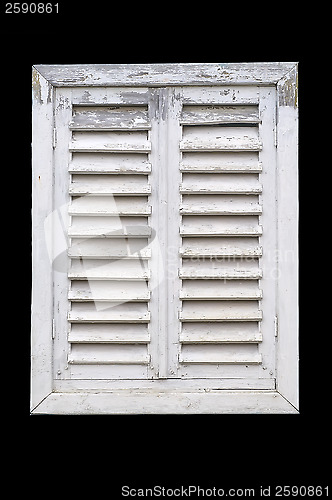 Image of Old white window with wooden shutters.