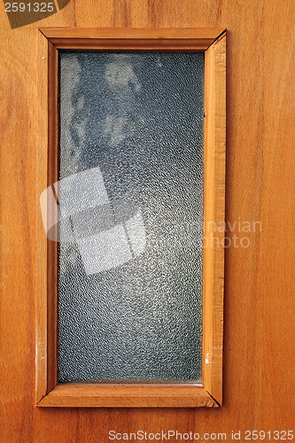 Image of window in wood door, textured plywood 