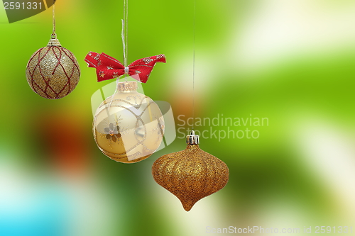 Image of three gold christmas baubles