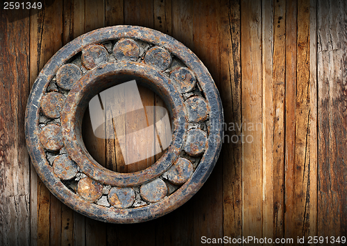 Image of huge rusty ball bearing hung on the wall