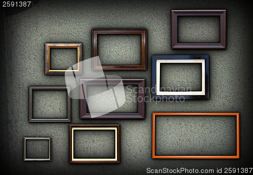 Image of green grungy wall full of frames