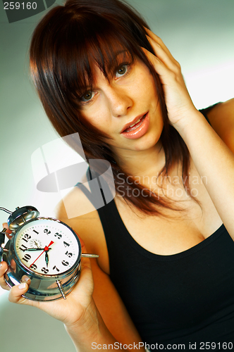 Image of brunette with clock