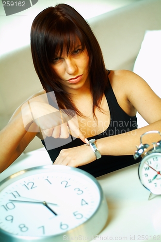 Image of brunette with clock