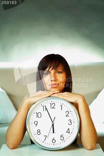 Image of brunette with clock