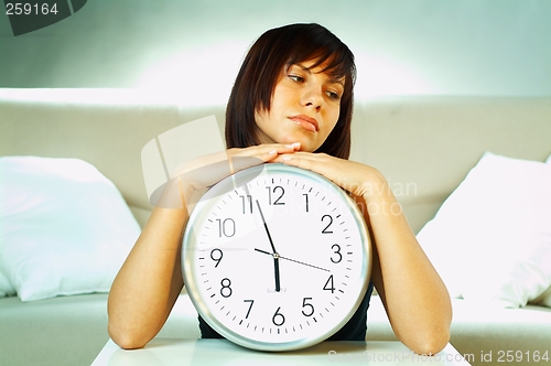 Image of brunette with clock