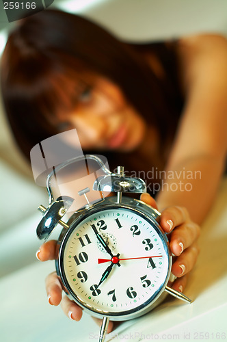 Image of brunette with clock