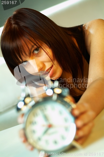 Image of brunette with clock