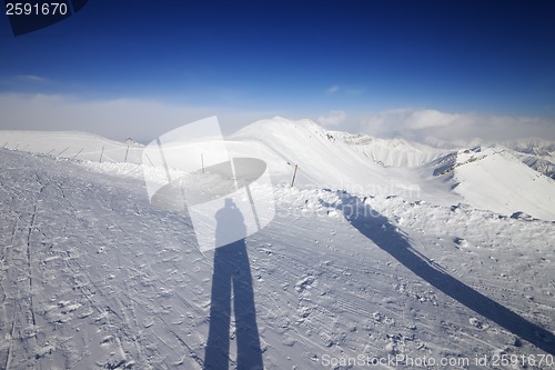 Image of Shadows of skier and snowboarder on snow