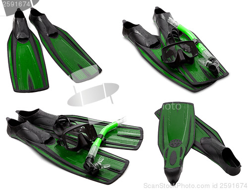 Image of Set of green flippers, mask, snorkel for diving with water drops