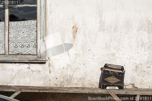 Image of wall and accordion on the bench background