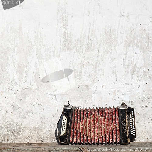 Image of wall and accordion on the bench