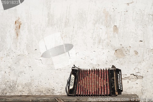 Image of wall and accordion on the bench background