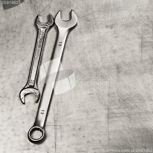 Image of Spanners, wrenches on a metal plate