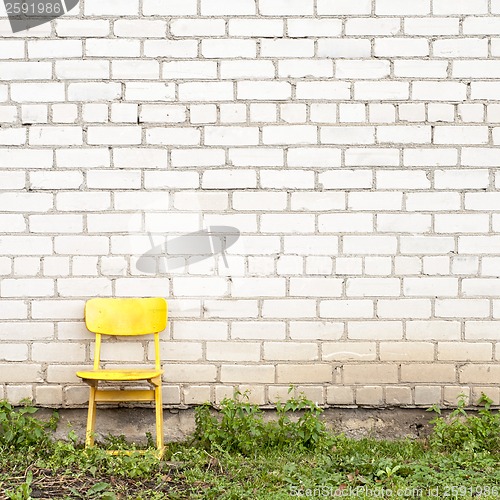 Image of brick wall and yellow seat