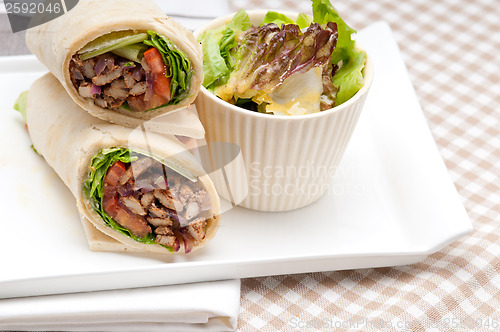 Image of kafta shawarma chicken pita wrap roll sandwich