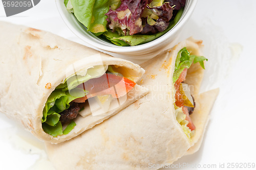 Image of kafta shawarma chicken pita wrap roll sandwich