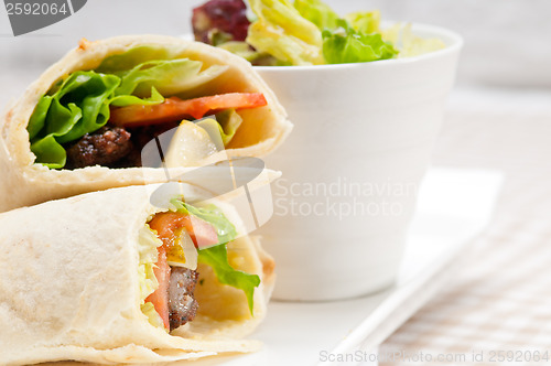 Image of kafta shawarma chicken pita wrap roll sandwich