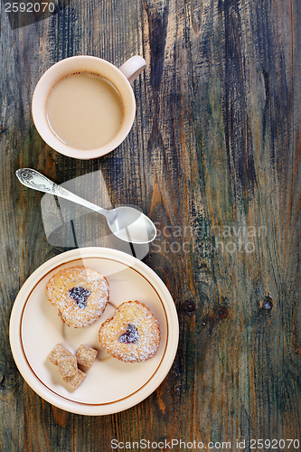 Image of Coffee saucer with biscuits and cane sugar.