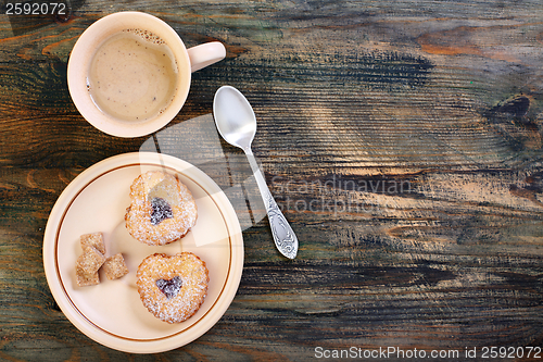 Image of Coffee and cookies in the shape of heart.