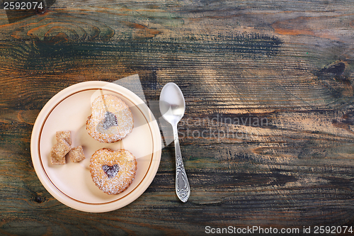 Image of Teaspoon and saucer with biscuits.