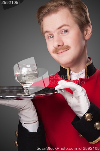 Image of Smiling Waiter in red uniform