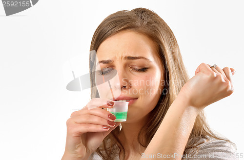 Image of girl taking cough syrup