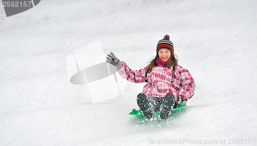 Image of girl sliding on sled 