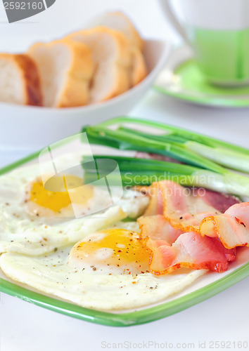 Image of breakfast with bacon and fried eggs