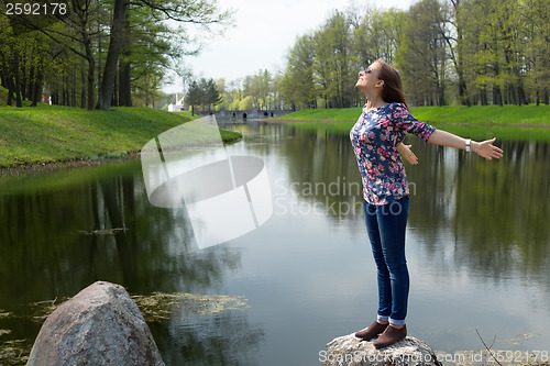 Image of beautiful young woman opened her hands