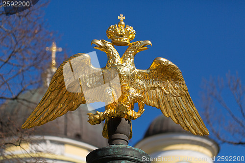 Image of golden double-headed eagle on a background of blue sky