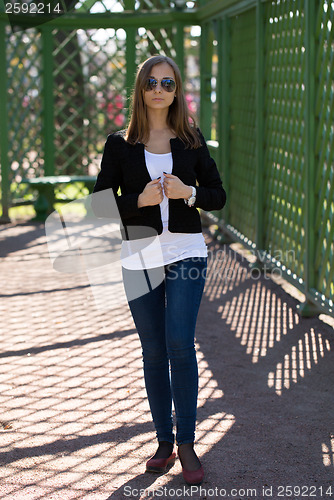 Image of trendy beautiful girl with sunglasses in a greenhouse