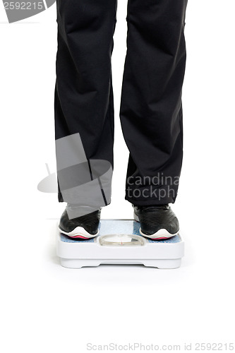 Image of Feet on scales isolated on white background