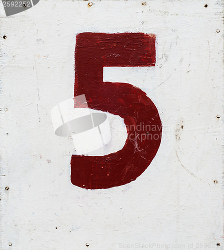Image of number five on white plywood board