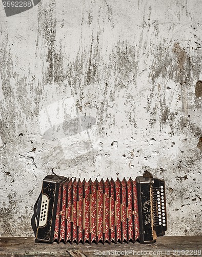 Image of wall and accordion on the bench background